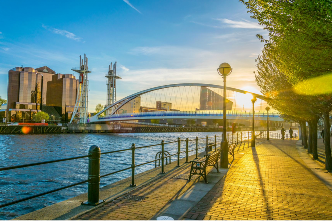 A picture of a city with the sun setting in the background 